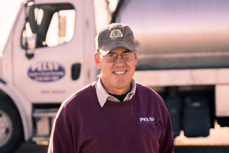 Roger Pelsy standing in front of his septic truck